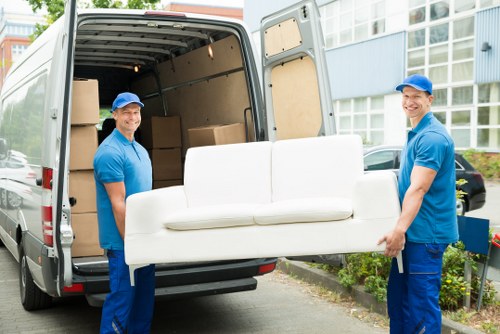 Man With Van Harlington team loading recyclable moving materials into a van