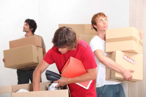 Packed household boxes and furniture ready for a local move in Harlington