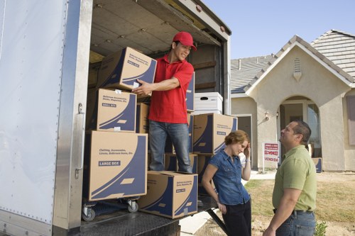 Professional movers loading household items safely for a Harlington relocation