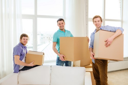Local movers handling packed boxes during a home relocation in Harlington