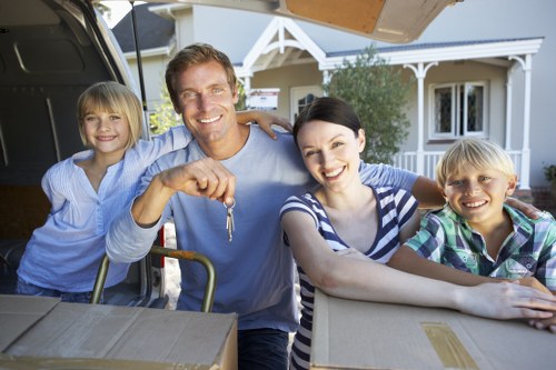 Professional movers handling fragile items and furniture during a Harlington house move