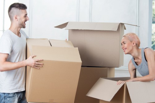 Staff member using safe lifting techniques during a house move