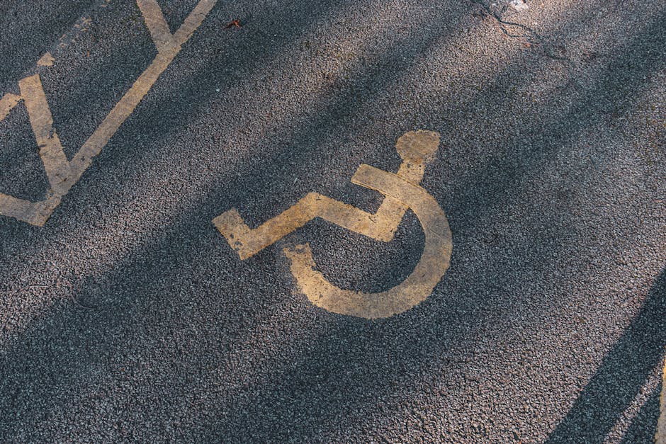 A pair of parking signs are mounted on a metal pole against a backdrop of leafless branches and an overcast sky. The top sign is blue with a large white letter 'P', indicating designated parking, whil
